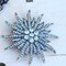 Sun-Shaped Gunmetal Brooch with Charcoal Rhinestones for Vintage Costume Accessories